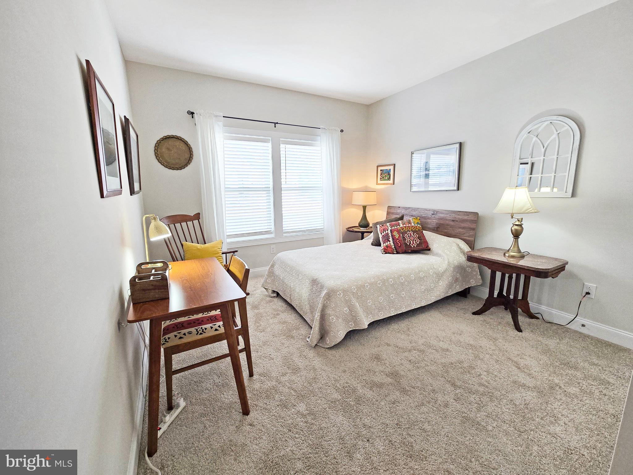 33768 Catching Cove Lewes, DE 19958 - Photo 26 of 69 a bedroom with a bed a couch and a window