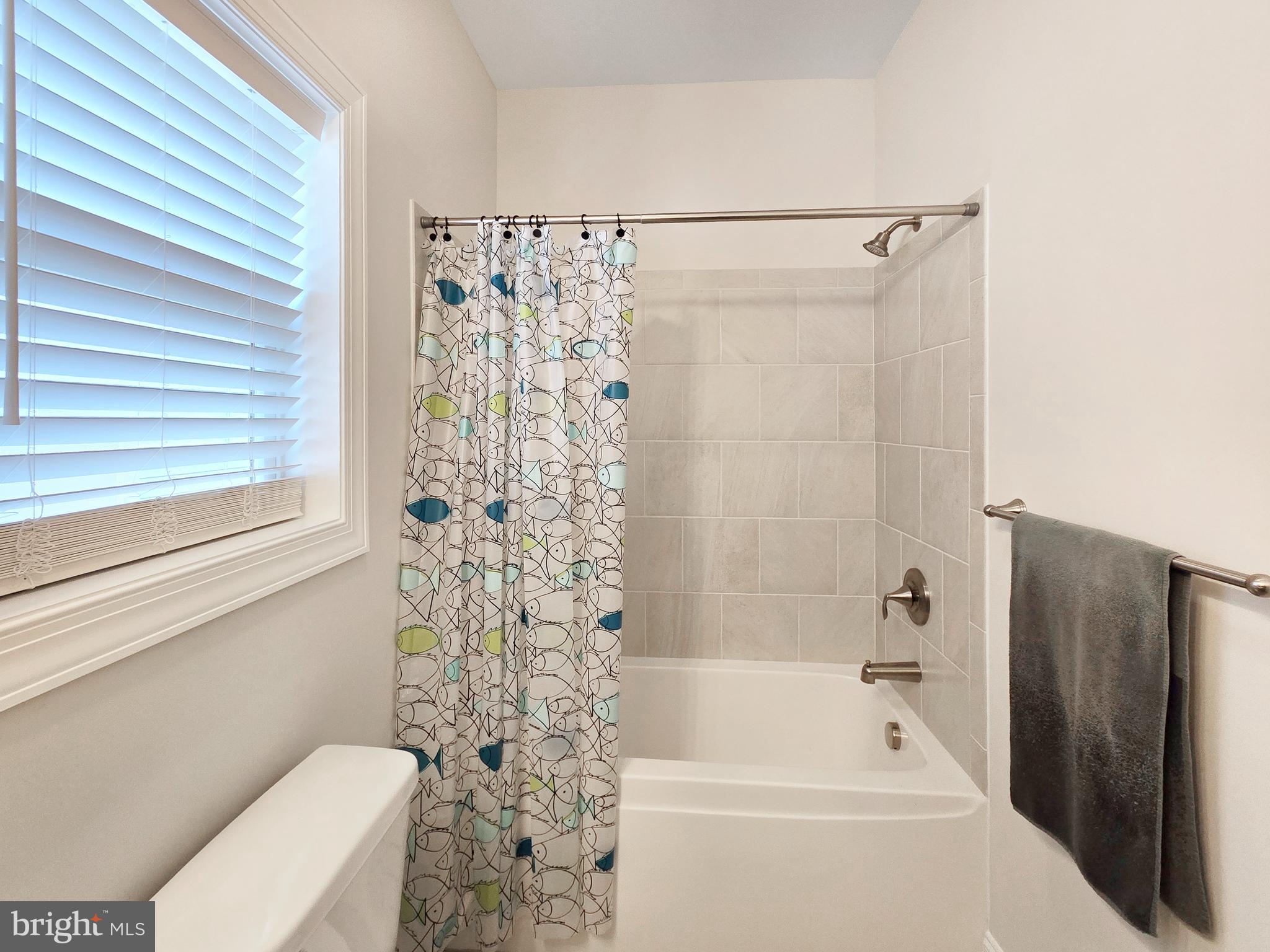 33768 Catching Cove Lewes, DE 19958 - Photo 29 of 69 a bathroom with a toilet and a bathtub