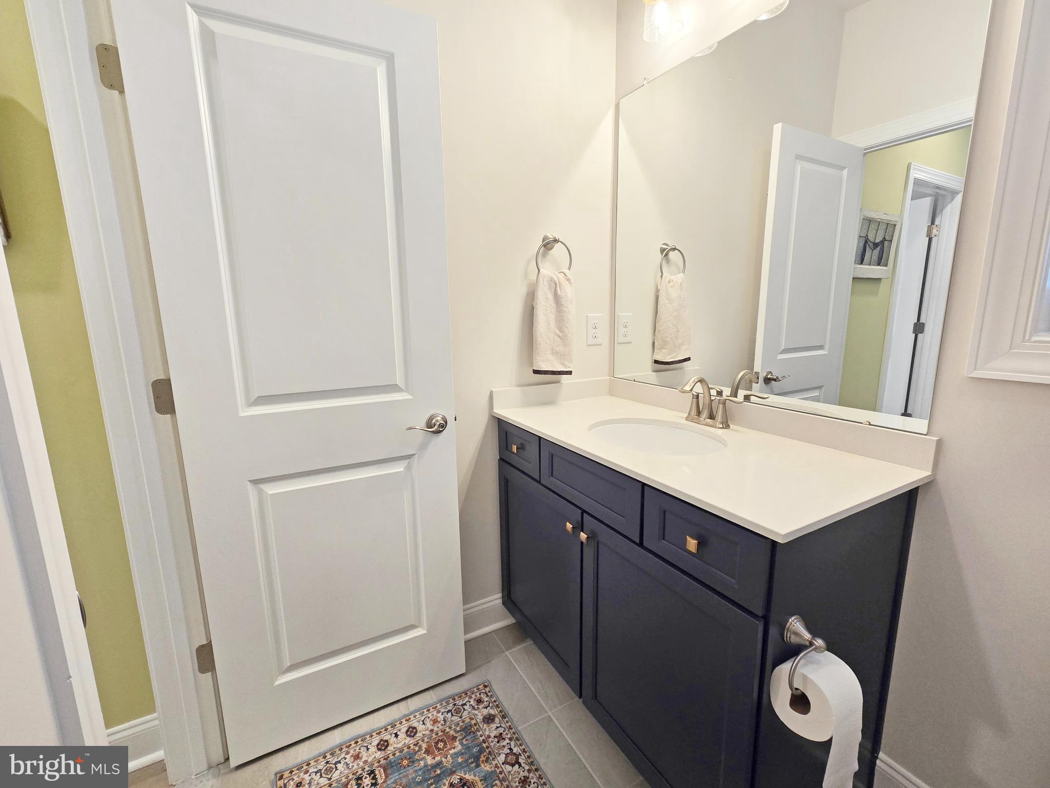 33768 Catching Cove Lewes, DE 19958 - Photo 30 of 69 a bathroom with a sink vanity and a mirror
