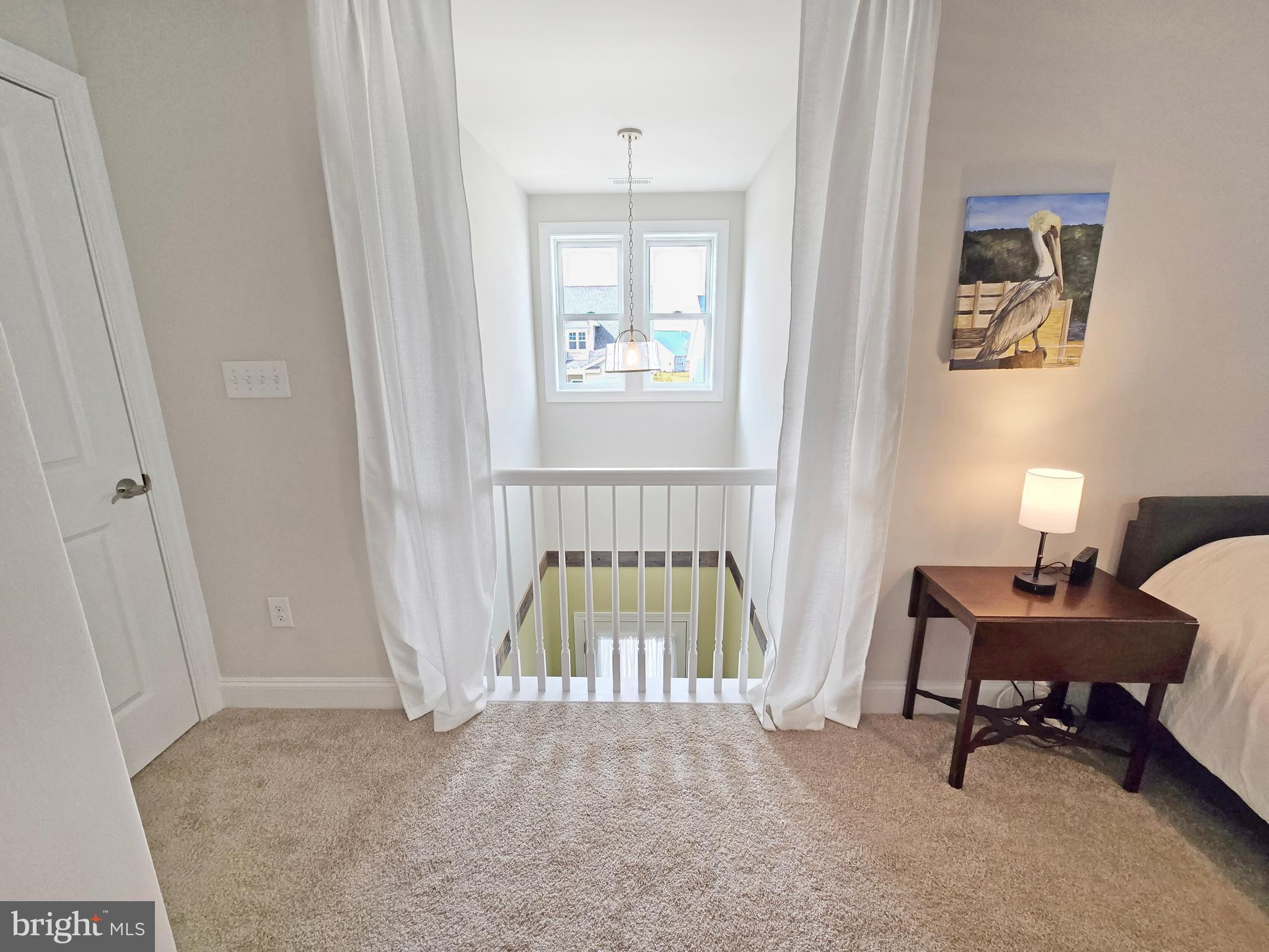 33768 Catching Cove Lewes, DE 19958 - Photo 32 of 69 a spacious bedroom with a bed and a window