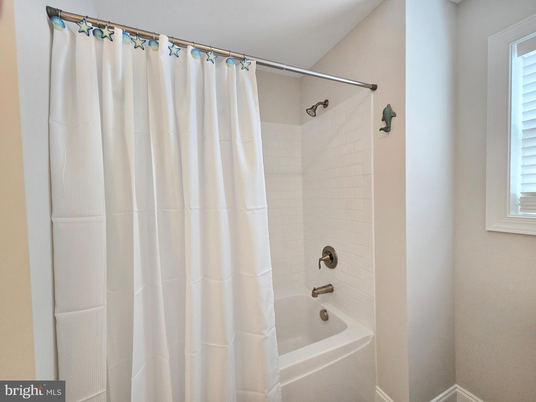 33768 Catching Cove Lewes, DE 19958 - Photo 38 of 69 a bathroom with a shower and a bath tub