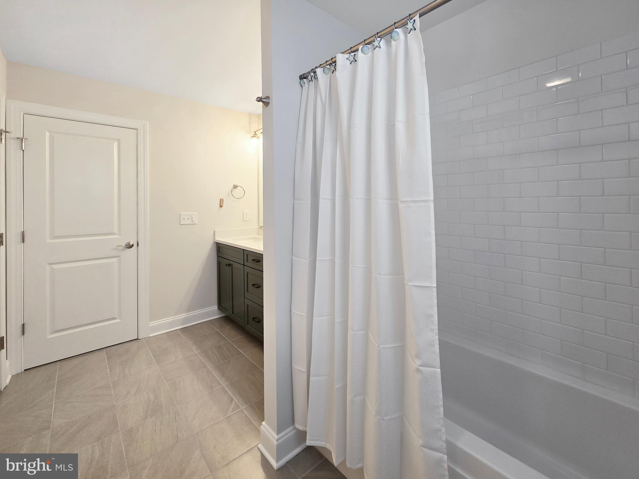 33768 Catching Cove Lewes, DE 19958 - Photo 40 of 69 a bathroom with a shower and a tub