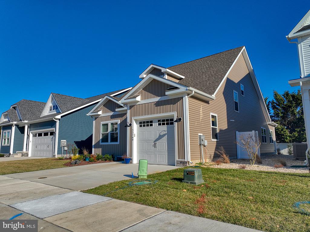 33768 Catching Cove Lewes, DE 19958 - Photo 45 of 69 a front view of a house with a yard