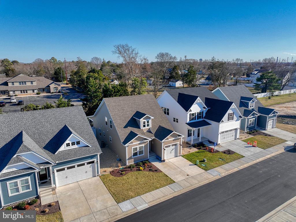 33768 Catching Cove Lewes, DE 19958 - Photo 50 of 69 an aerial view of a house with swimming pool and a yard