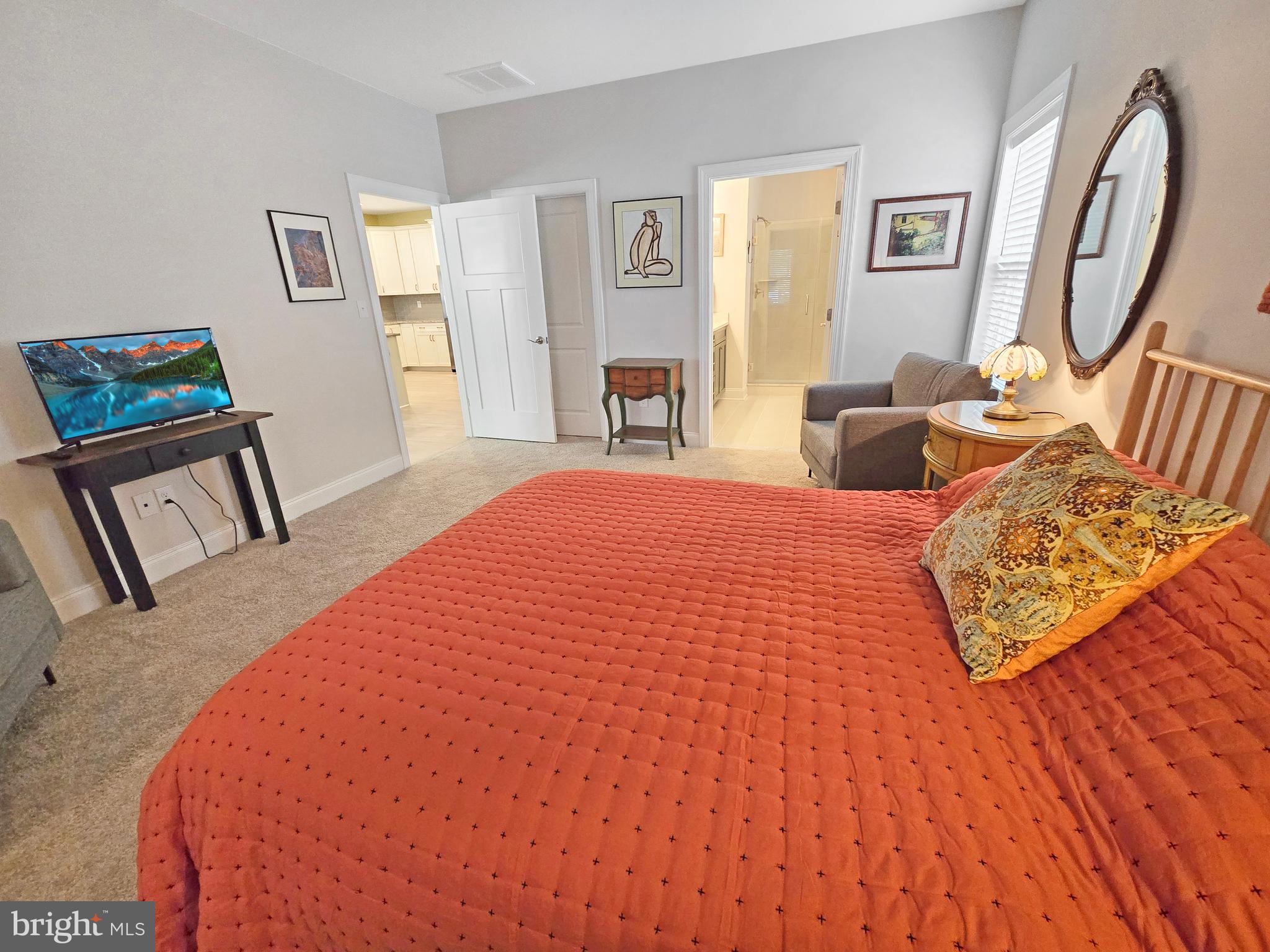 33768 Catching Cove Lewes, DE 19958 - Photo 8 of 69 a bedroom with a bed and a mirror on dresser