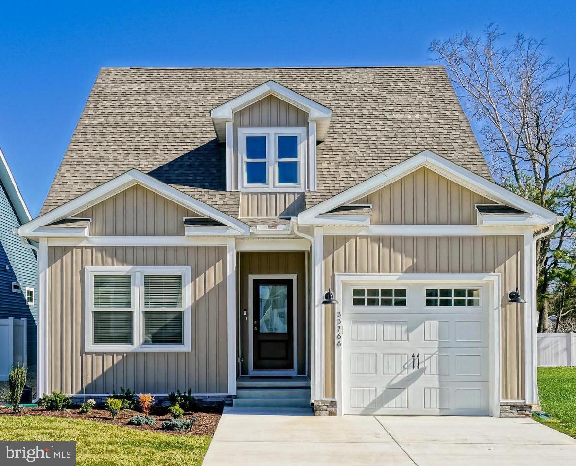 33768 Catching Cove Lewes, DE 19958 - Photo 10 of 69 a front view of a house with a yard