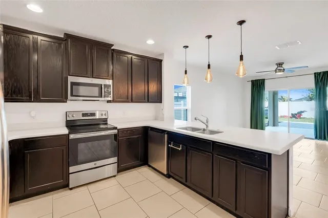 a kitchen with a refrigerator sink and microwave
