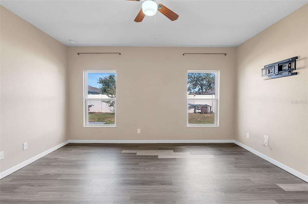 2620 Wadeview Loop St. Cloud, FL 34769 - Photo 14 of 38 an empty room with wooden floor and windows