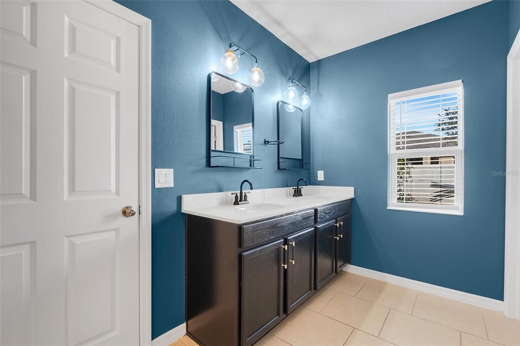 2620 Wadeview Loop St. Cloud, FL 34769 - Photo 16 of 38 a kitchen with a sink and stove