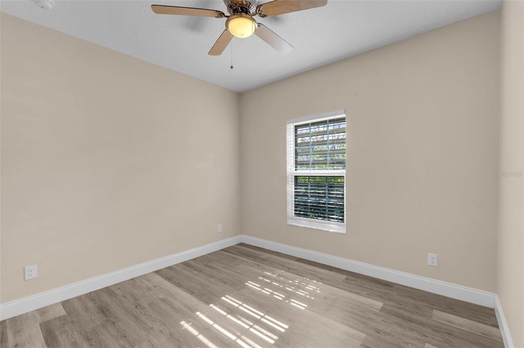 2620 Wadeview Loop St. Cloud, FL 34769 - Photo 19 of 38 wooden floor in an empty room with a window