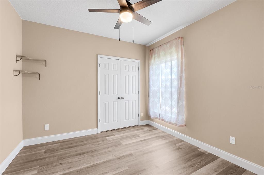 2620 Wadeview Loop St. Cloud, FL 34769 - Photo 24 of 38 wooden floor in an empty room with a window