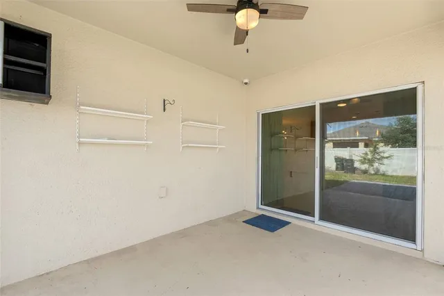 a backyard of a house with table and chairs