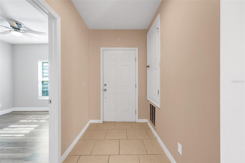 2620 Wadeview Loop St. Cloud, FL 34769 - Photo 3 of 38 a view of a hallway to rooms