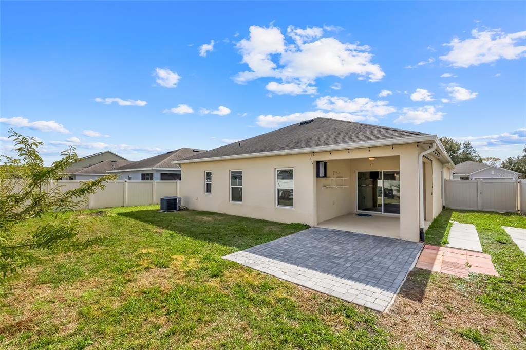2620 Wadeview Loop St. Cloud, FL 34769 - Photo 32 of 38 a view of a house with a yard