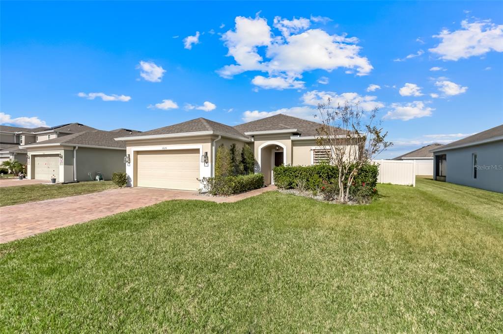 2620 Wadeview Loop St. Cloud, FL 34769 - Photo 37 of 38 a front view of a house with a garden