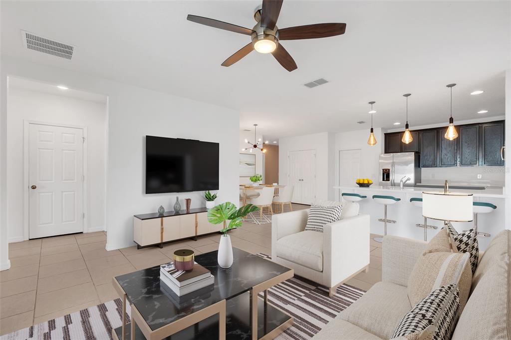 2620 Wadeview Loop St. Cloud, FL 34769 - Photo 4 of 38 a living room with furniture and a flat screen tv