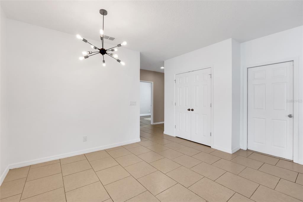 2620 Wadeview Loop St. Cloud, FL 34769 - Photo 8 of 38 a view of a chandelier fan in white room