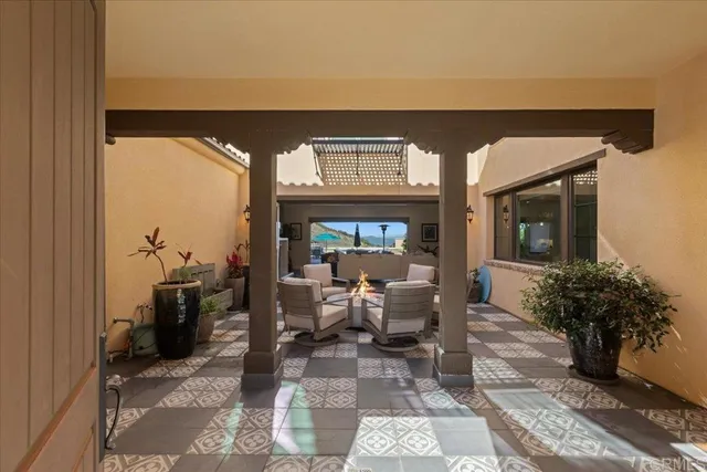 a work room with furniture a rug and a bookshelf