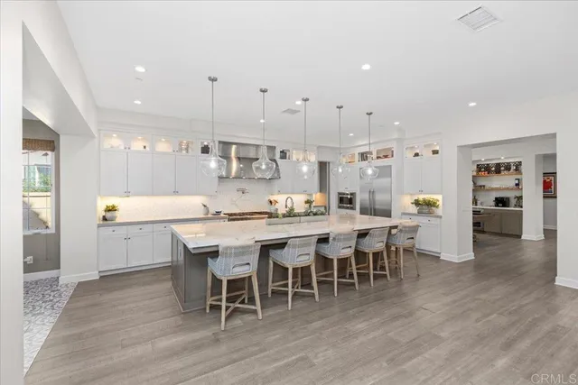 a dining room with furniture a chandelier and wooden floor