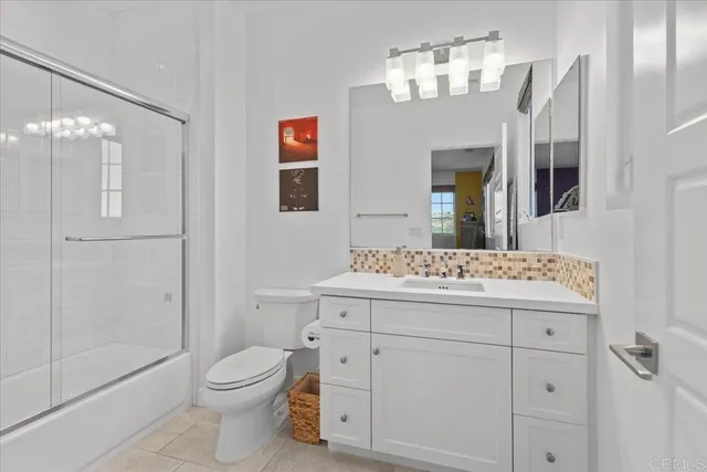 a spacious bathroom with a double vanity sink a large mirror and a bathtub