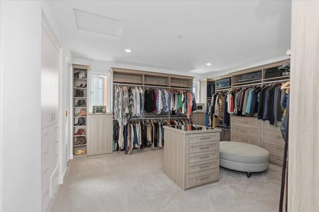 a view of a patio with table and chairs under an umbrella with a small yard