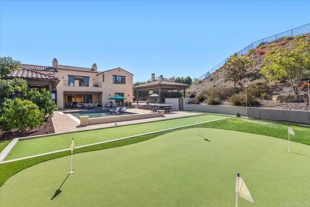 an aerial view of a house with a mountain