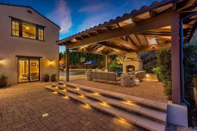a view of a patio with table and chairs under an umbrella
