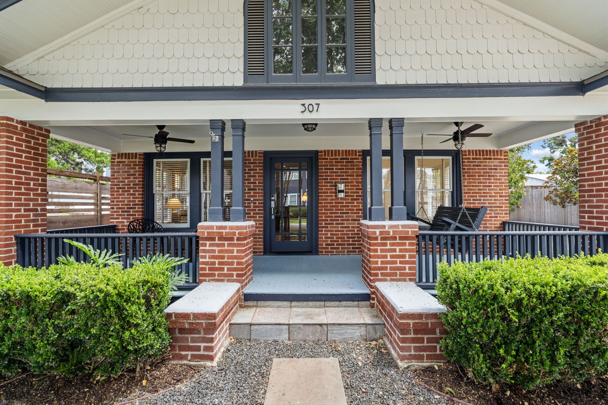 307 East 8th Street Houston, TX 77007 - Photo 3 of 35 Welcoming covered front porch with brick columns, decorative wood posts, dual ceiling fans, and a porch swing creates the perfect outdoor living space. Ring security doorbell conveys.
