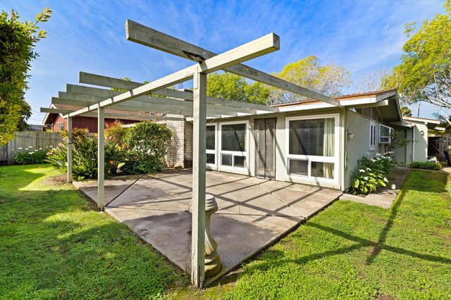 a view of a house with backyard from a patio