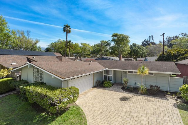 an aerial view of a house with a yard and lake view
