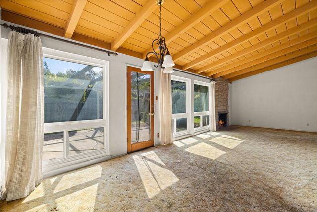 a view of a room with wooden floor and furniture