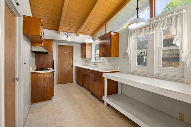 a kitchen with stainless steel appliances granite countertop a sink and cabinets