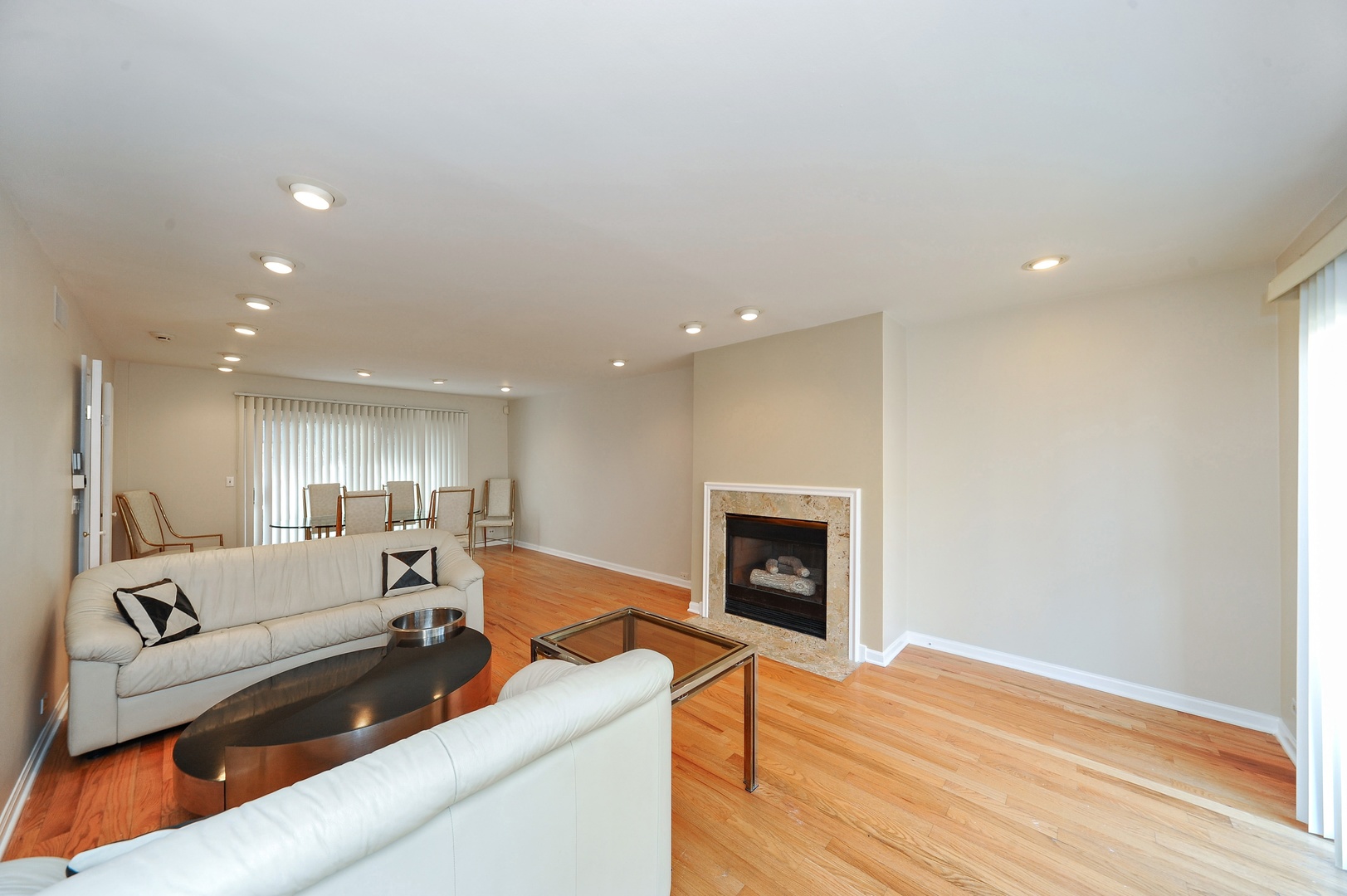 138 Green Bay Road, Unit 138 Glencoe, IL 60022 - Photo 2 of 10 a living room with furniture and a fireplace