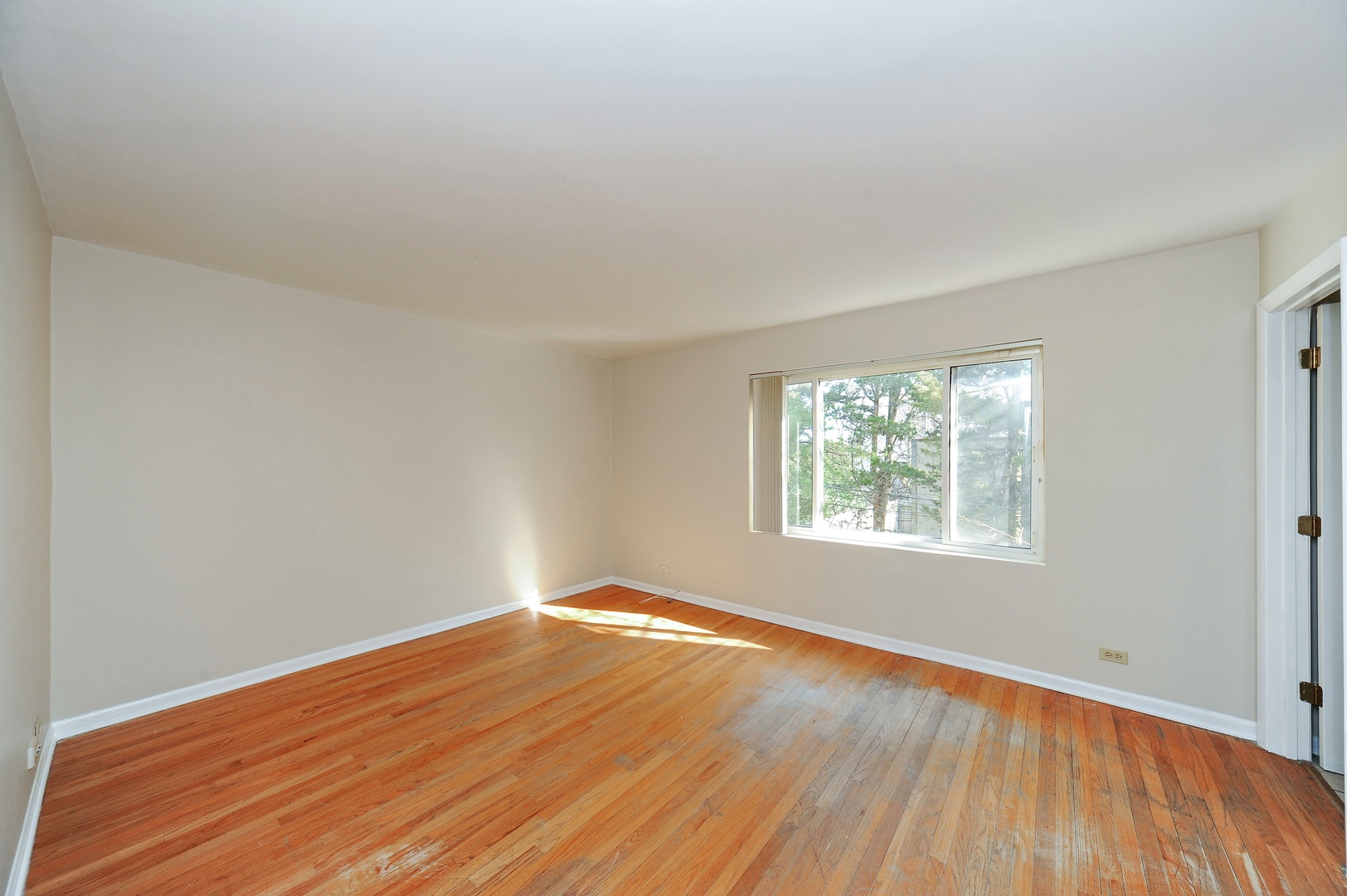138 Green Bay Road, Unit 138 Glencoe, IL 60022 - Photo 5 of 10 an empty room with wooden floor and windows