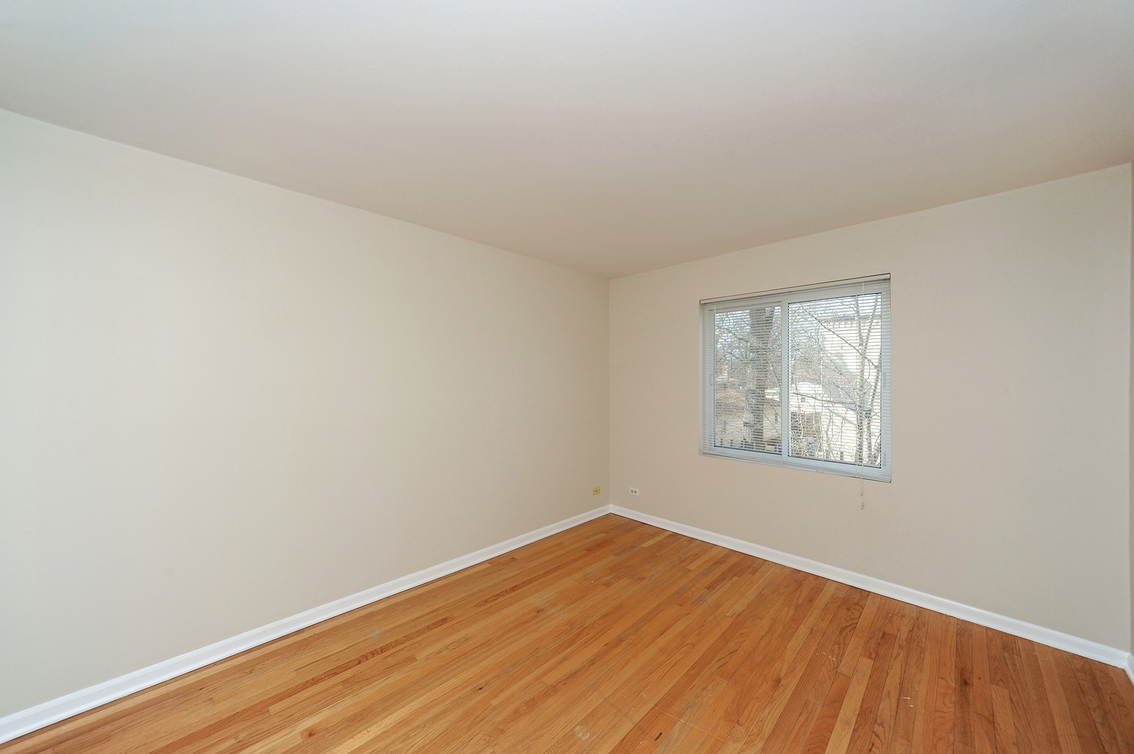 138 Green Bay Road, Unit 138 Glencoe, IL 60022 - Photo 6 of 10 an empty room with wooden floor and windows
