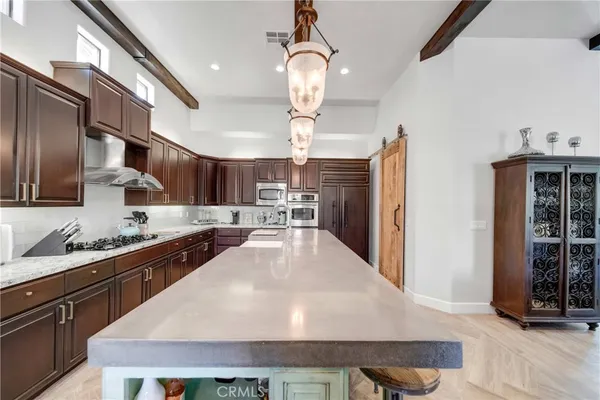 a kitchen with stainless steel appliances granite countertop a refrigerator stove a sink and dishwasher