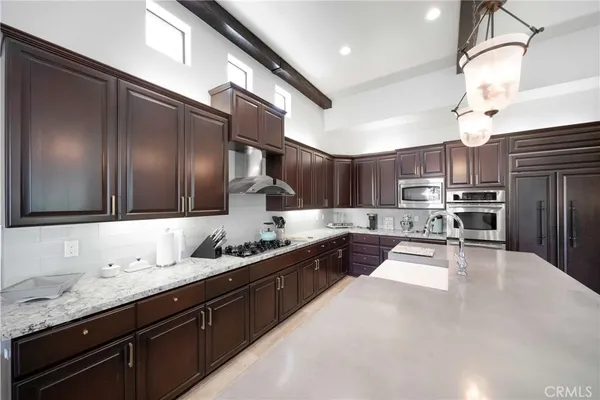 a large white kitchen with a large window