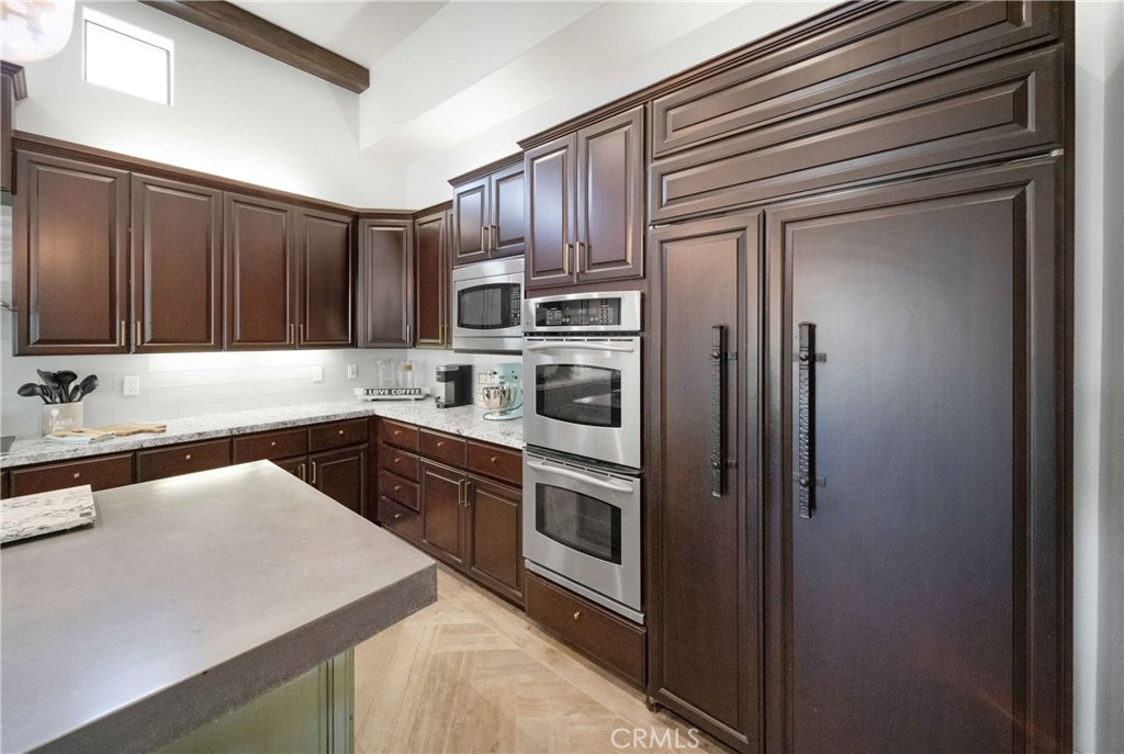57721 Santa Rosa Trail La Quinta, CA 92253 - Photo 13 of 68 a kitchen with stainless steel appliances granite countertop a refrigerator stove a sink and dishwasher