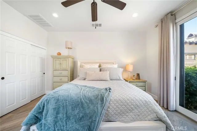 a bedroom with a bed couch tv and a window