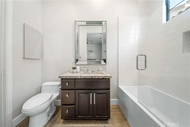 a spacious bedroom with a bed and a chandelier
