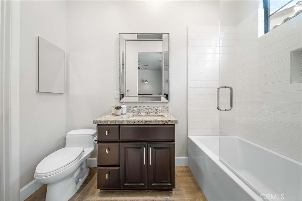 57721 Santa Rosa Trail La Quinta, CA 92253 - Photo 23 of 68 a bathroom with a granite countertop toilet a sink and bathtub