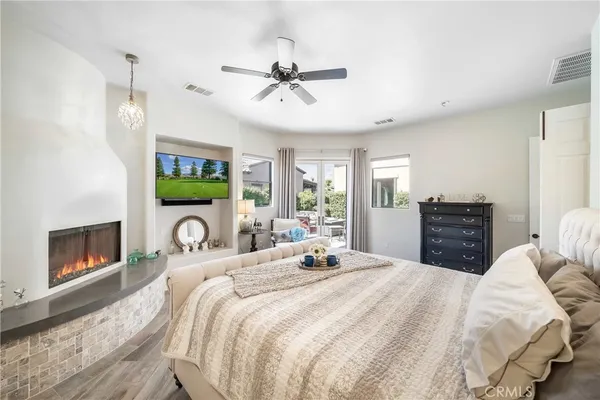 a bedroom with a bed and a chandelier