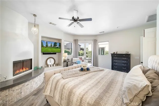 a bedroom with a bed and a chandelier