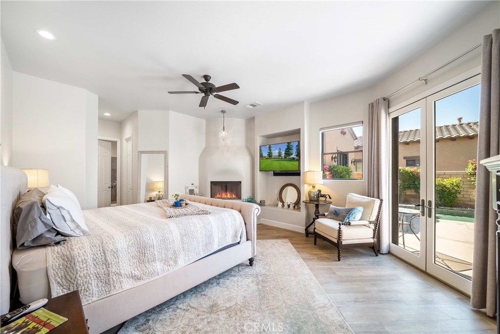 57721 Santa Rosa Trail La Quinta, CA 92253 - Photo 28 of 68 a spacious bedroom with a bed and a chandelier