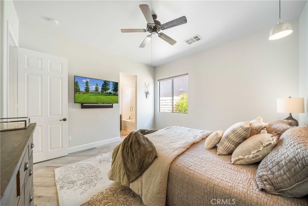 57721 Santa Rosa Trail La Quinta, CA 92253 - Photo 30 of 68 a bedroom with a bed and a chandelier
