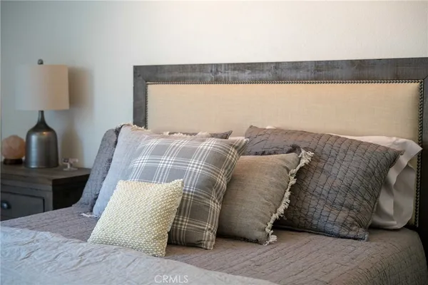 a bedroom with a bed and a chair