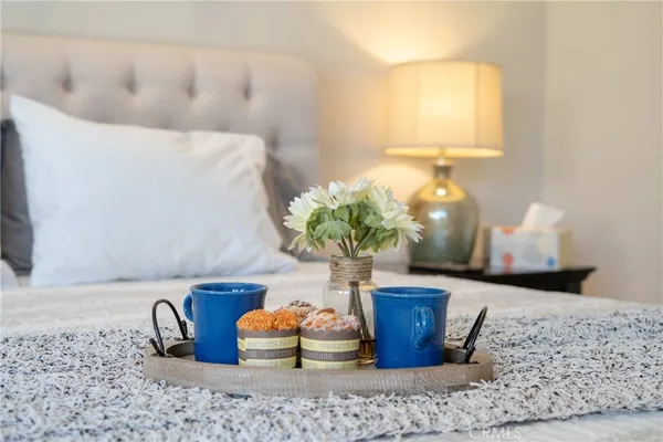a spacious bedroom with a bed and a chandelier