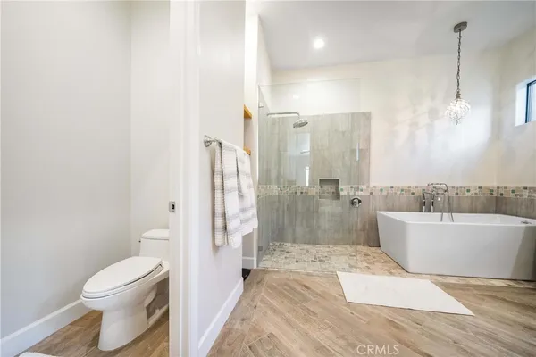 a bathroom with a sink vanity granite tub shower and a mirror