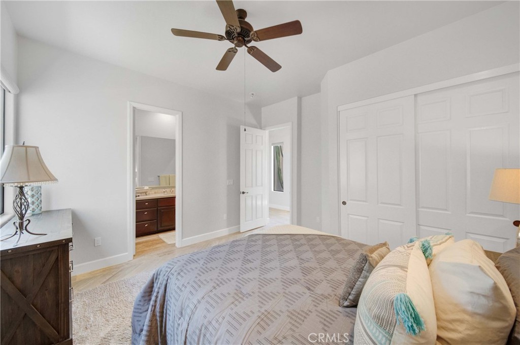 57721 Santa Rosa Trail La Quinta, CA 92253 - Photo 39 of 68 a spacious bedroom with a bed and a chandelier