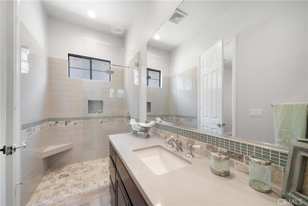 57721 Santa Rosa Trail La Quinta, CA 92253 - Photo 41 of 68 a bathroom with a sink vanity granite tub shower and a mirror